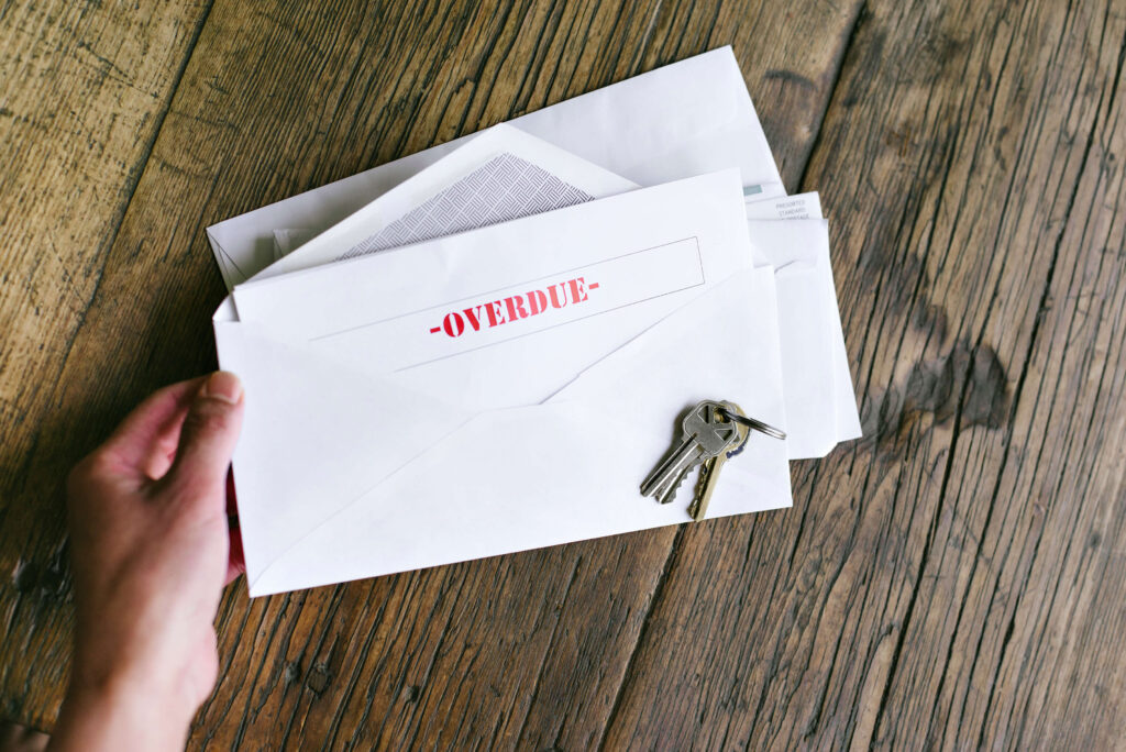 Tips for Handling Phoenix Tenants Who Are Late Paying Rent renter in phoenix holding overdue rent notification